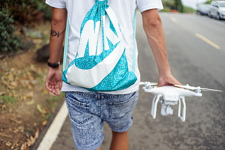 man holding white DJI Phantom 4 thumbnail