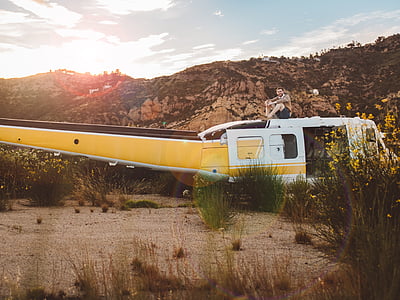 white and yellow helicopter near grass thumbnail