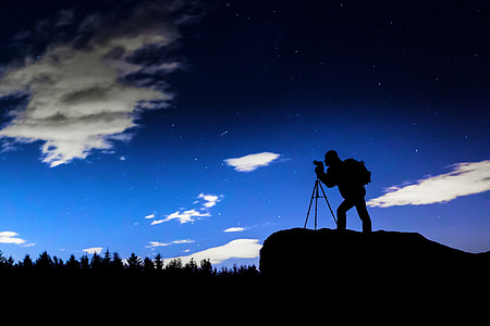 silhouette of person standing on cliff thumbnail
