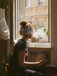 woman smoking cigarette while looking in the mirror thumbnail