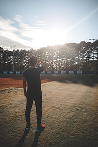 Man Standing on Field Looking on Trees thumbnail