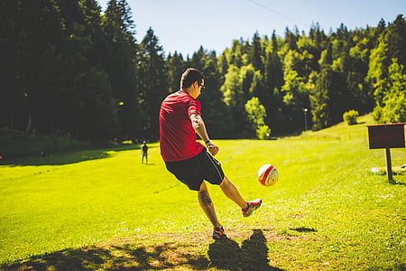 man playing soccer on green grass field thumbnail