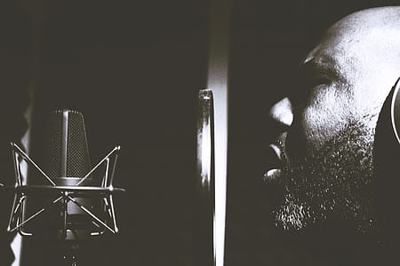 Man Singing Near Pop Filter and Condensing Microphone thumbnail