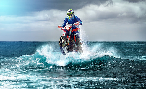person ride on motocross dirt bike on body of water thumbnail