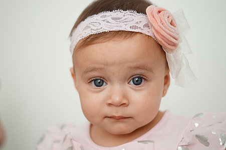 closeup photo of toddler in white lace headband thumbnail