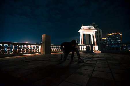 person making tricks on terrace during night time thumbnail