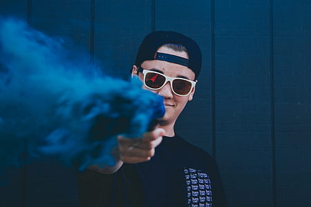 man holding blue smoke bomb thumbnail