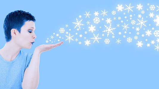 woman blowing snowflakes thumbnail