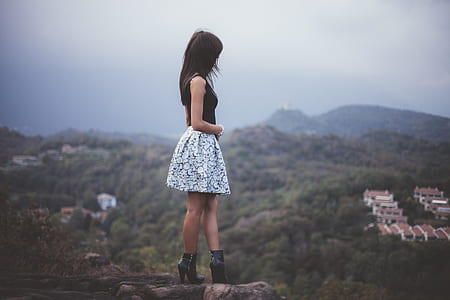 shallow focus photography of woman on top of mountain thumbnail