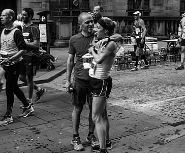 grayscale photo of man and woman standing at the road thumbnail
