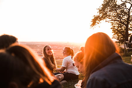 group of person seating on field thumbnail
