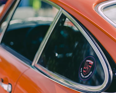 orange car under sunny sky thumbnail