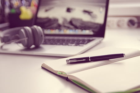 MacBook Pro near black click pen and notebook thumbnail