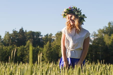 woman in white top standing on grass field thumbnail