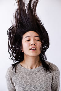 woman wearing gray crew-neck sweatshirt against white background thumbnail