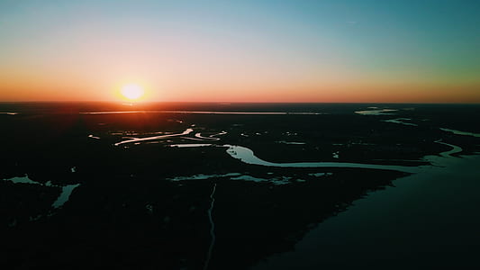 aerial photo of green land under golden sky thumbnail