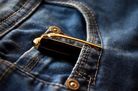 black and gold pen inside blue denim bottoms pocket thumbnail