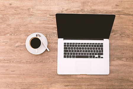 black and gray MacBook pro with white ceramic coffee mug thumbnail
