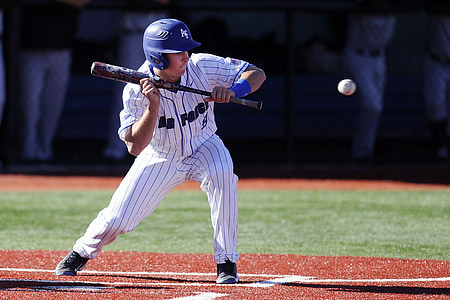 man playing baseball during daytime thumbnail