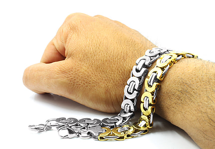 person wearing two silver-and-gold-colored bracelets thumbnail