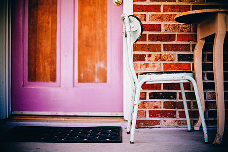 selective focus photography of chair placed near door thumbnail