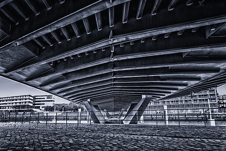 low angle photography of bridge near buildings thumbnail