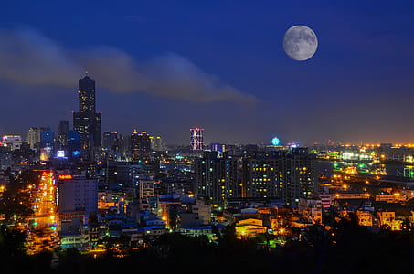 city buildings under full moon during thumbnail