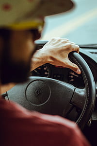 man in red top driving Renault car thumbnail
