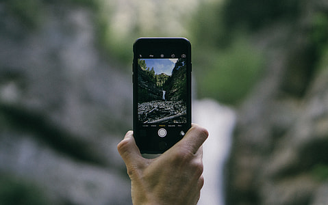 person holding space gray iPhone 5s thumbnail