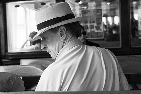 Man Wearing Polo Shirt and Hat in Grayscale Photo thumbnail