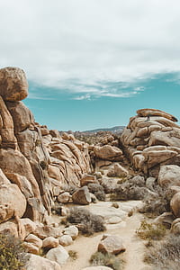 person standing on rock mountain during daytime thumbnail