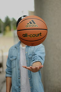 shallow focus photography of black and brown adidas basketball thumbnail