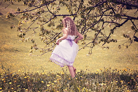 girl in pink playing on grass field thumbnail