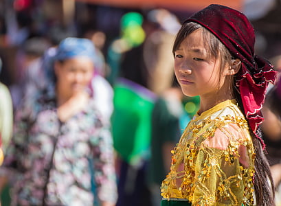 girl in red turban and yellow floral top near people thumbnail