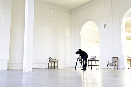 person standing beside camera inside building thumbnail