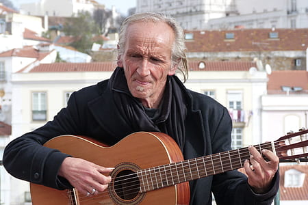 man playing classic guitar at daytime thumbnail