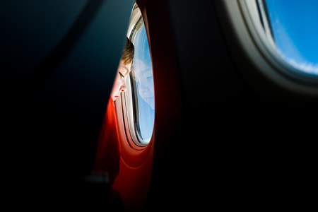 boy inside airliner facing window thumbnail