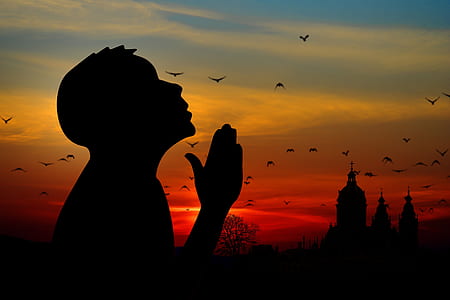 silhouette photography of person praying thumbnail