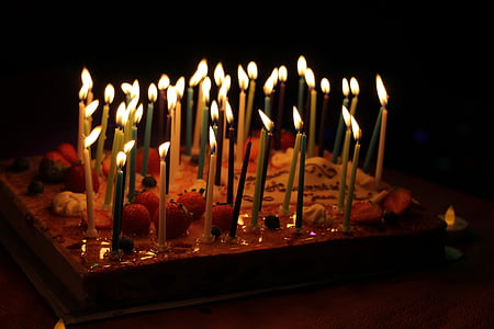 rectangular strawberry cake with lighted candles thumbnail