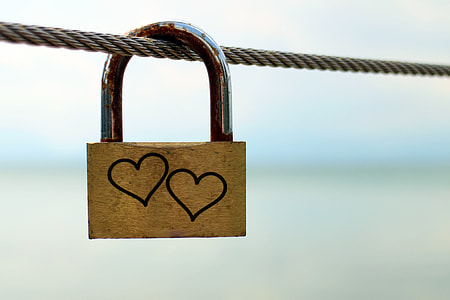 brown padlock with two heart carve hanged in brown rope thumbnail