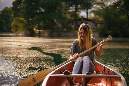 woman rowing boat at daytime thumbnail
