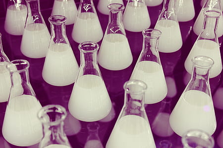 clear glass erlenmeyer flask with white liquid lot thumbnail