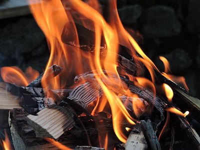 wood burning near concrete wall thumbnail