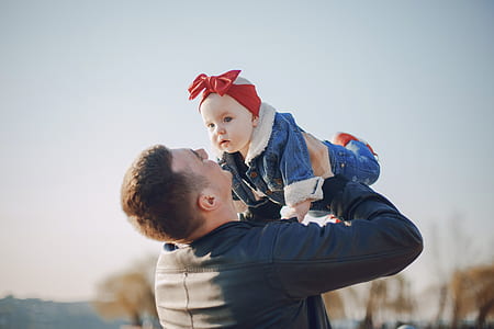 man carrying baby thumbnail