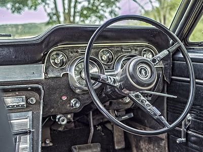closeup photograph of steering wheel and car radio thumbnail