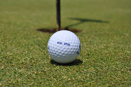 white Feel-Spin golf ball on top of golf course thumbnail