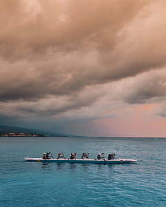 group of people riding kayak on beach thumbnail