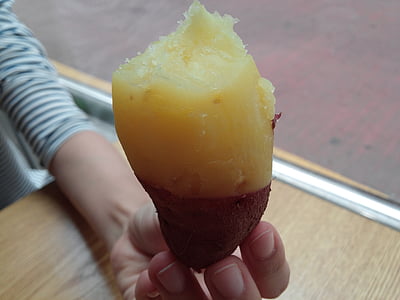 person holding sweet potato thumbnail