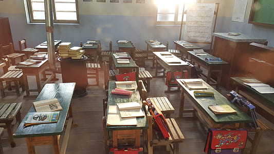 desk with books and bags inside classroom thumbnail