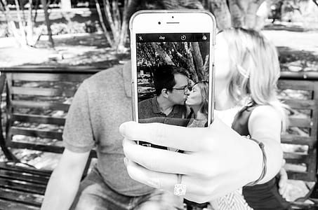 Gray Scale Photo of Man and Woman Taking a Selfie thumbnail